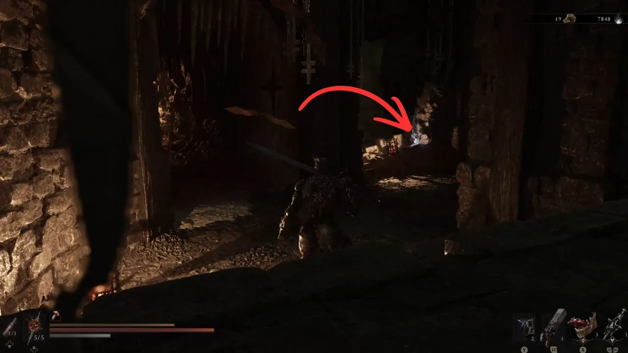 Image showing a Mortal Shell 2 player walking into the Sanguine Caverns Gate, with an arrow pointing to a Burnt Effigy